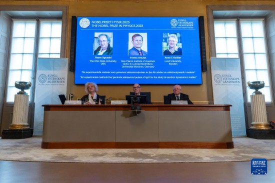 10月3日，在瑞典斯德哥爾摩舉行的2023年諾貝爾物理學(xué)獎公布現(xiàn)場，屏幕上顯示獎項得主皮埃爾·阿戈斯蒂尼（左）、費倫茨·克勞斯（中）和安妮·呂利耶的照片。新華社發(fā)（魏學(xué)超攝）
