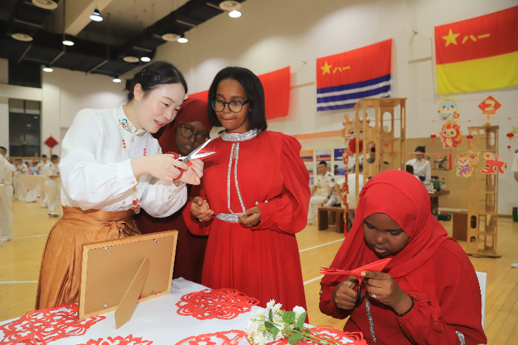 中國剪紙藝術(shù)吸引當(dāng)?shù)厝耸繀⑴c體驗(yàn)。陳錦俊攝