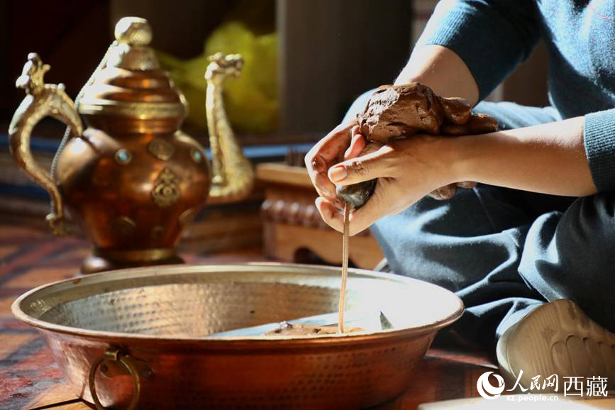 牛角鉆孔，將木泥擠出。人民網(wǎng)記者 次仁羅布攝