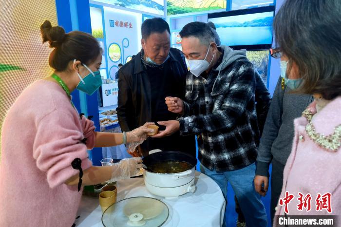 圖為杭州市民品嘗茶卡羊肉。　李雋 攝