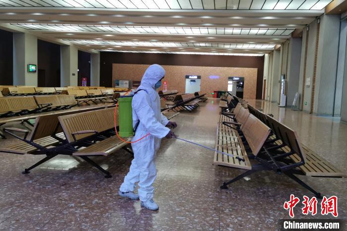 圖為拉薩車站工作人員在候車室進(jìn)行消毒。　李海星 攝