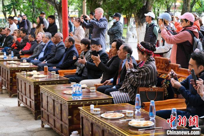 5月19日，中外嘉賓在羅布林卡和游客一起觀看藏戲。　江飛波 攝